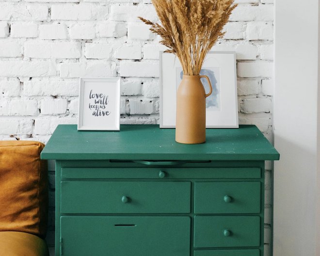 drawer with a frame and vase on it